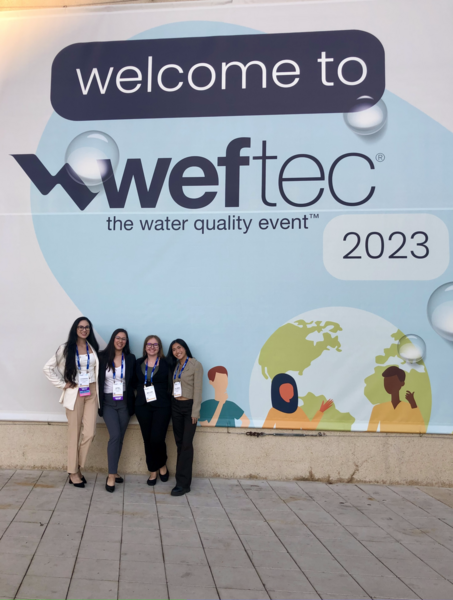 Senior Design Team at WEFTEC 2023 - standing by sign